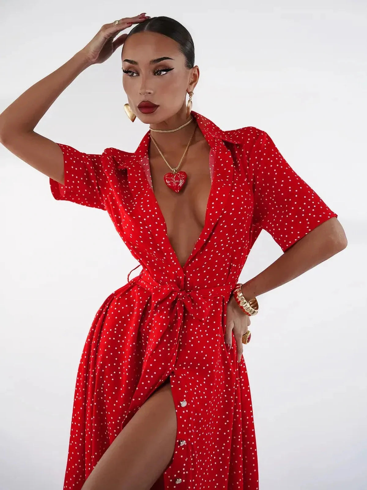 Stylish model showcasing the vibrant Scarlet Dot Midi Dress with playful polka dots and a cinched waist tie.
