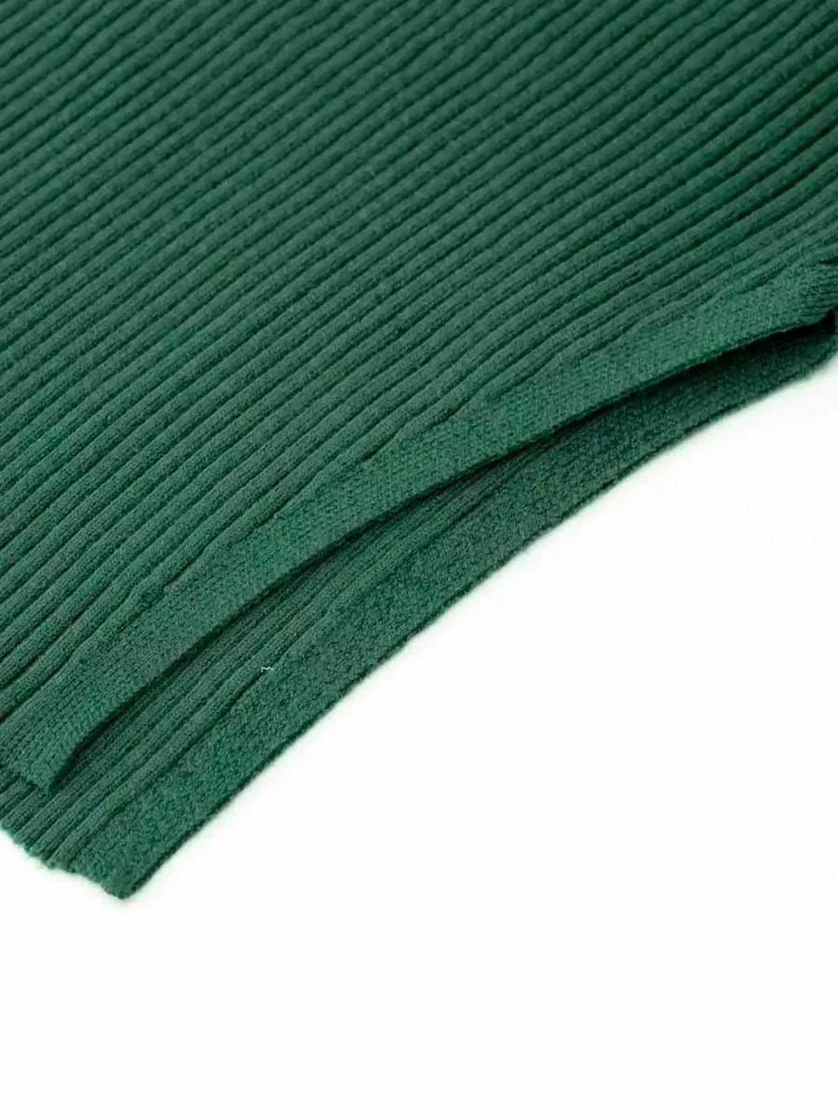 Close-up of lush forest green ribbed knit fabric, showcasing texture and quality perfect for a sculpted midi dress.