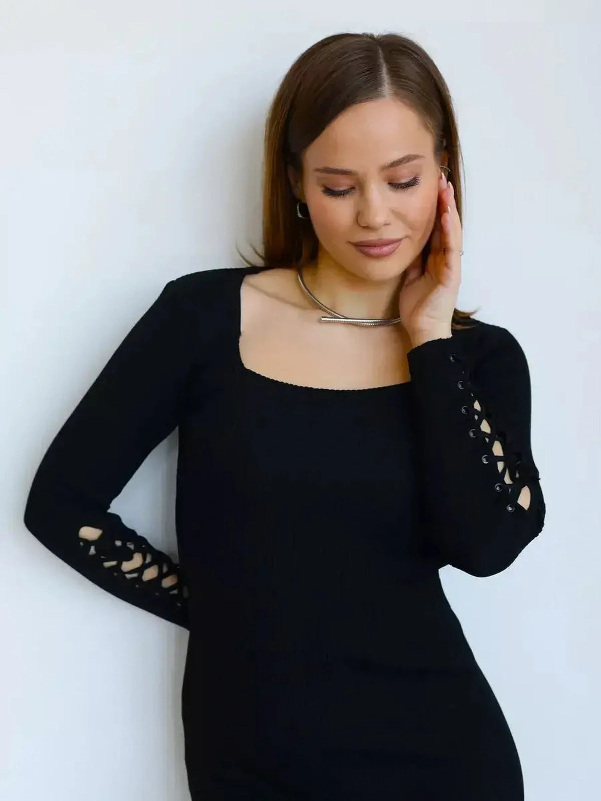 Model wearing Laced Allure Midi Dress showcasing lace-up sleeve accents against a neutral background.