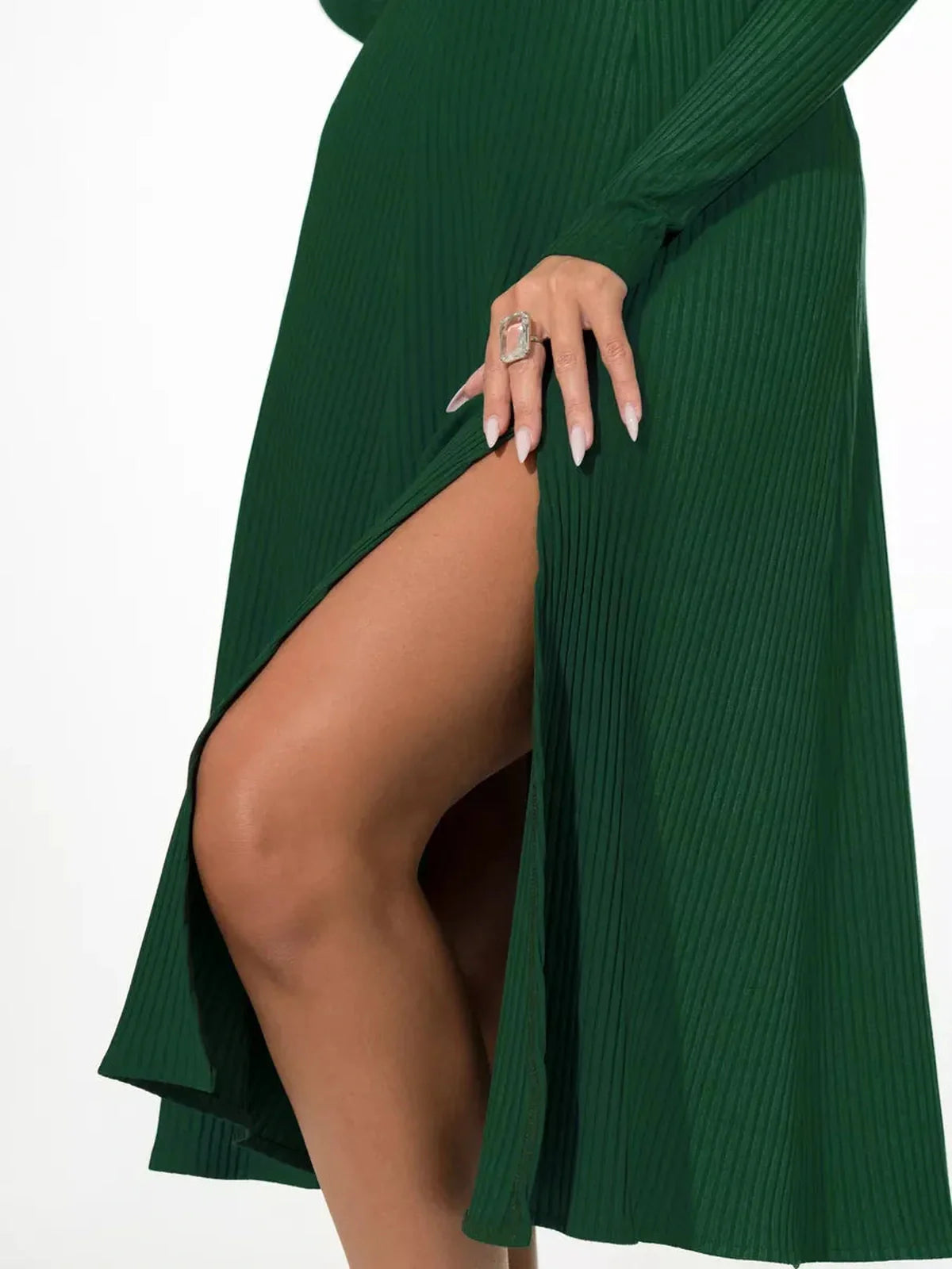 Close-up of the Emerald Grace Midi Dress showcasing a stylish thigh-high slit and rich green texture.