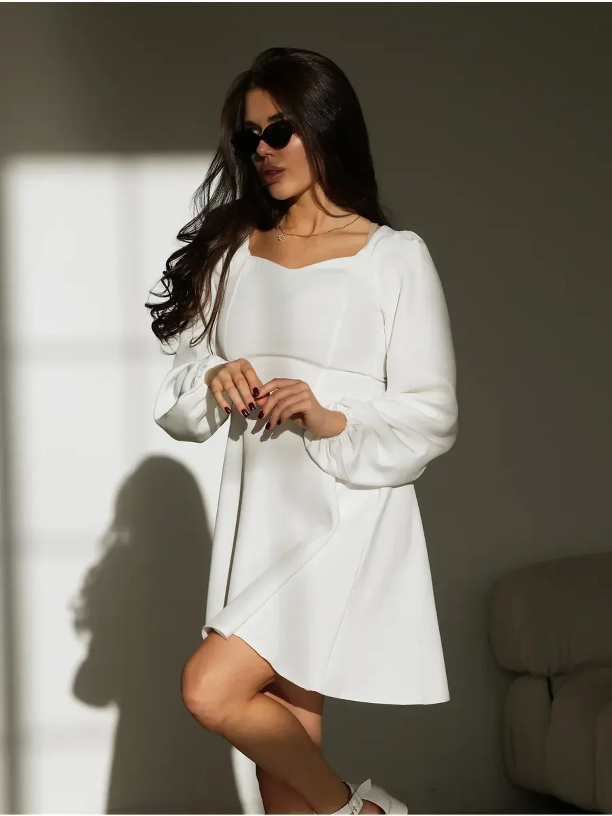 Elegant woman in a white dress with a sweetheart neckline, ideal for wedding guest and graduation dresses.