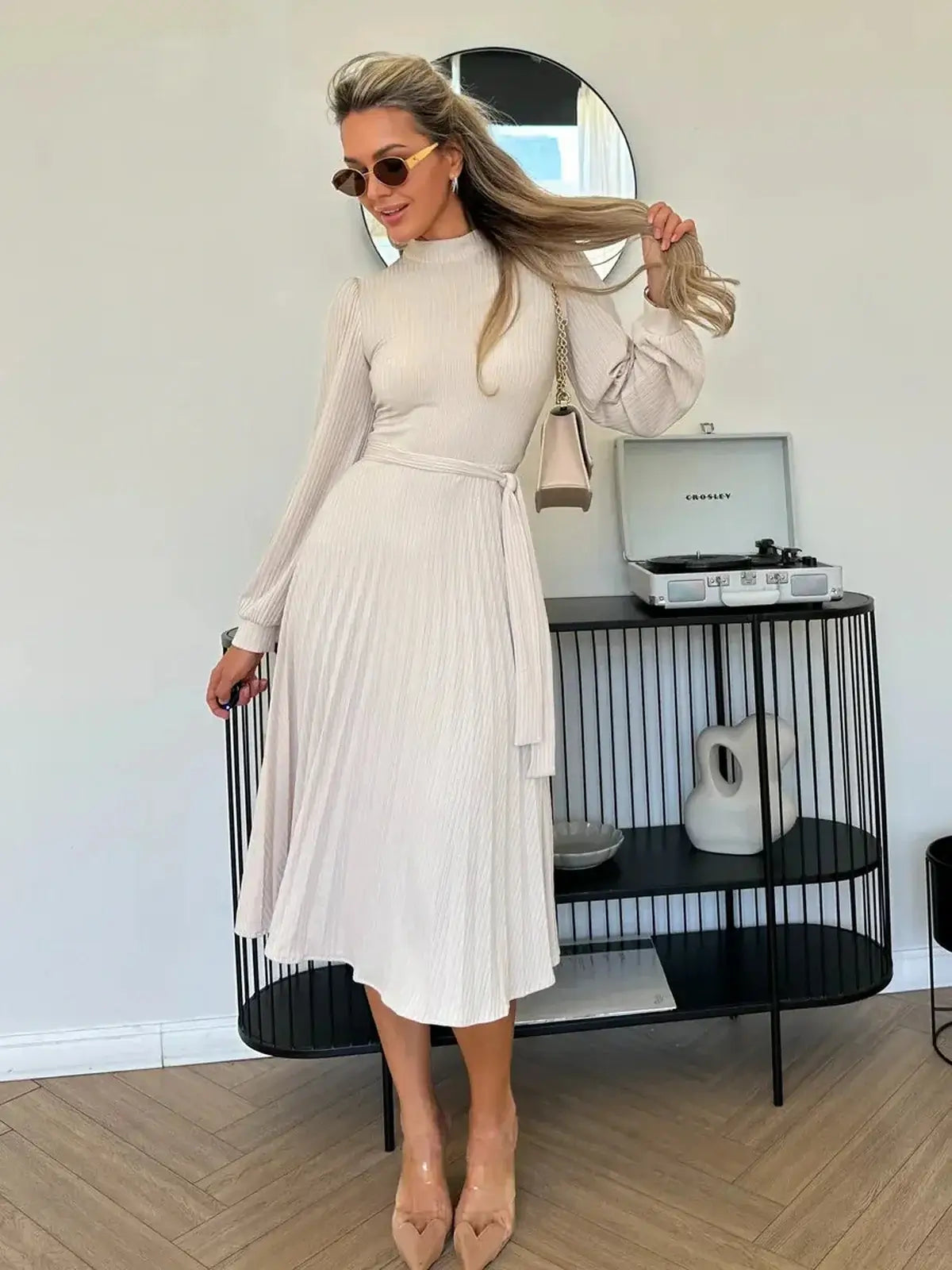 Ivory Whisper Midi Dress featuring ribbed knit texture, flowing pleated skirt, and high neck for elegant women's fashion.