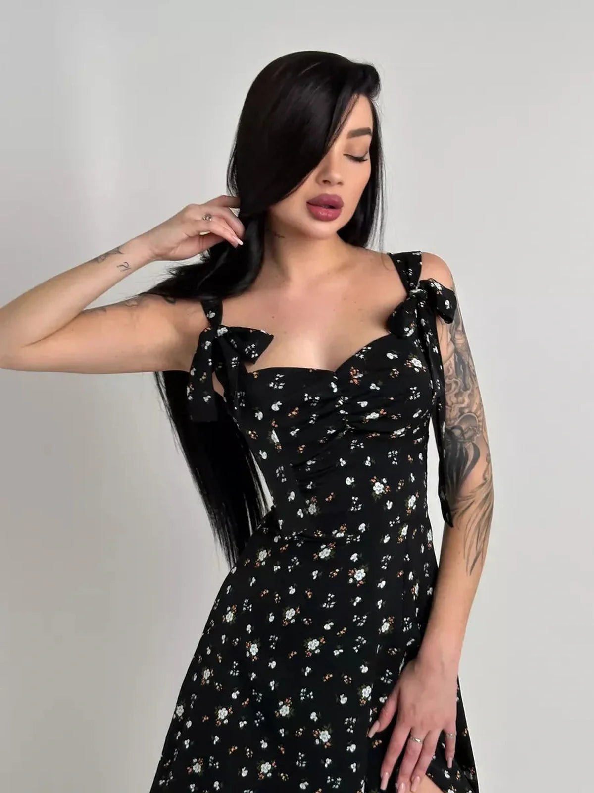 Elegant black floral Elysian Midi Dress with romantic bows, ideal for summer occasions and special events.