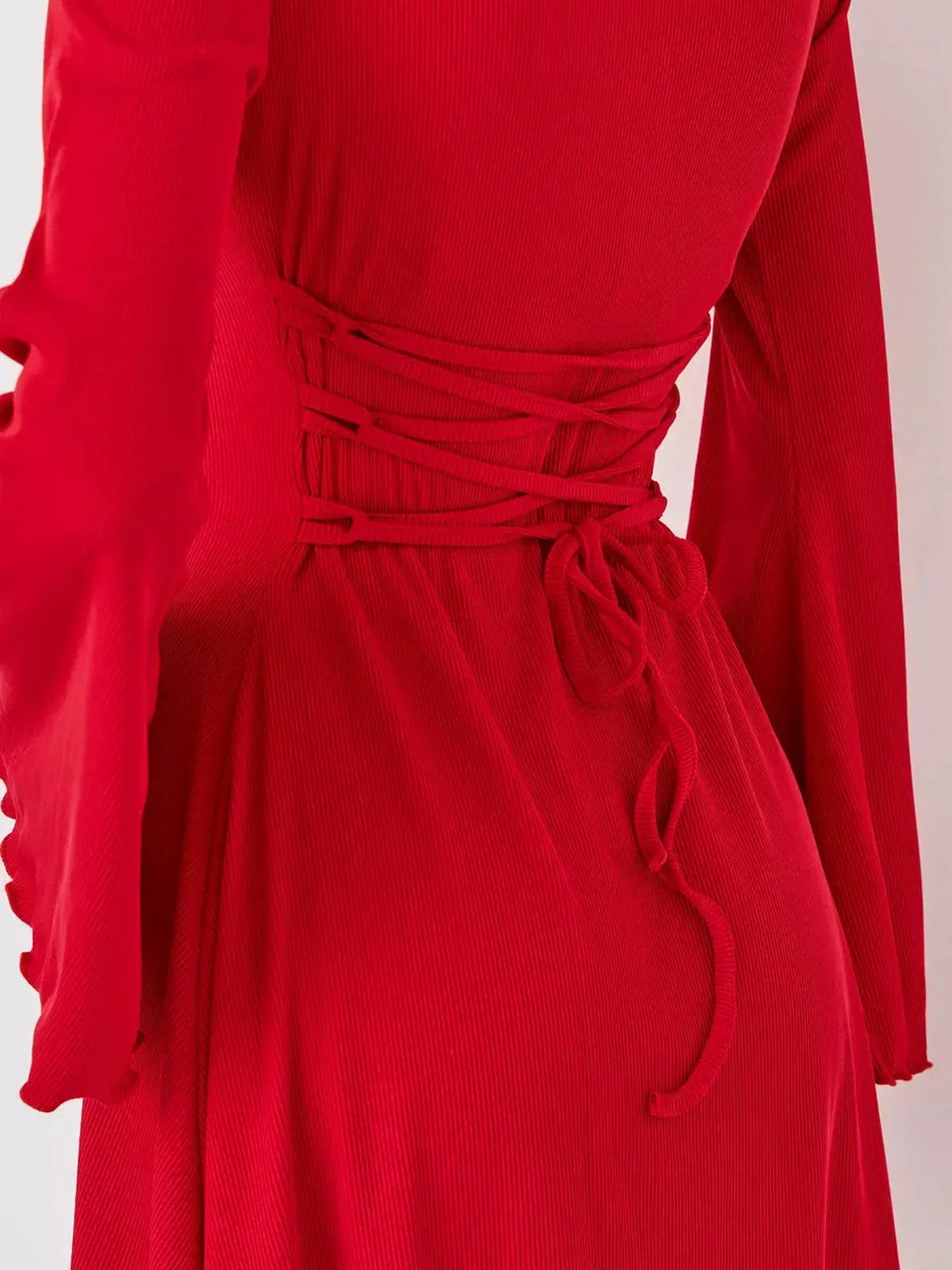 Close-up of the back detail of a red flare cutout mini dress, showcasing its stylish lacing and form-fitting design.