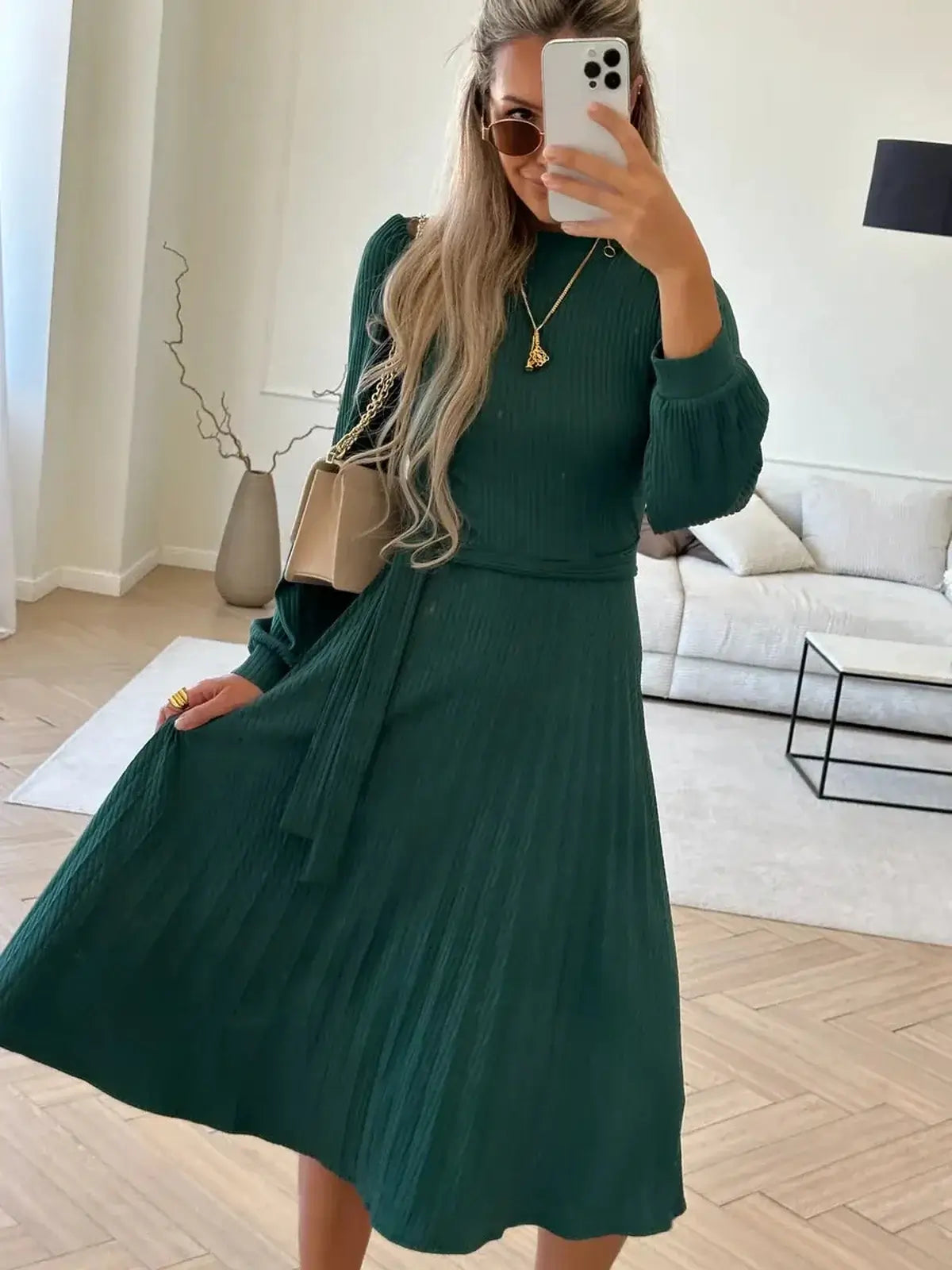 Emerald Poise Midi Dress featuring a pleated skirt, ribbed texture, and elegant long sleeves, perfect for weddings or casual outings.