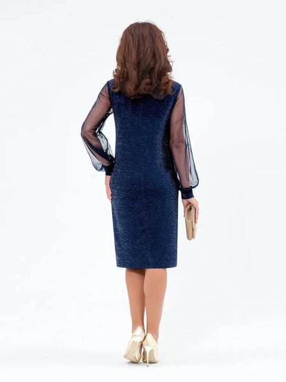 Back view of a woman wearing a navy blue Celeste Midi Dress with sheer sleeves, perfect for weddings and cocktail events.