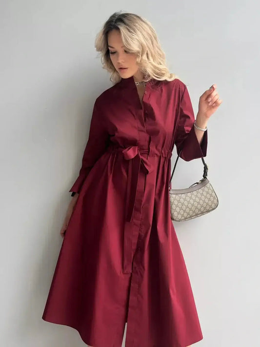 Burgundy Grace Midi Dress showcasing elegant A-line silhouette and tie belt, perfect for weddings and special occasions.