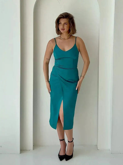 Sleek emerald green Lustre Midi Dress with wrap-effect front and thigh-high slit, perfect for weddings and formal events.