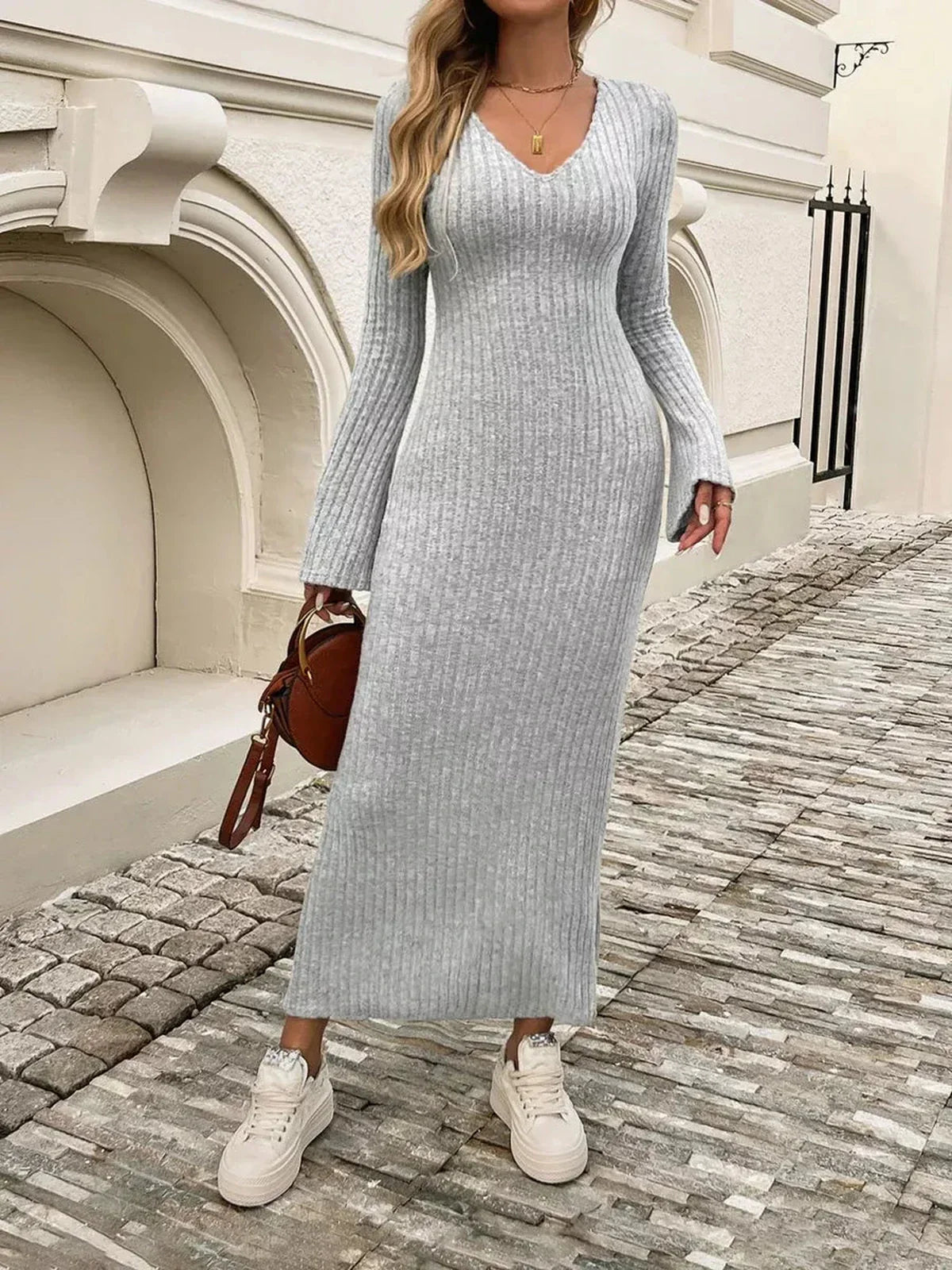Sculpted Soft Midi Dress in gray ribbed knit with flared sleeves, styled for modern city elegance.