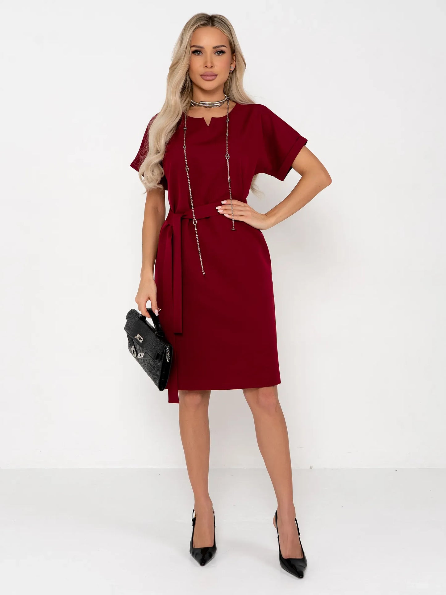 Model wearing a crimson red mini dress with a belt, perfect for summer weddings or cocktail events.