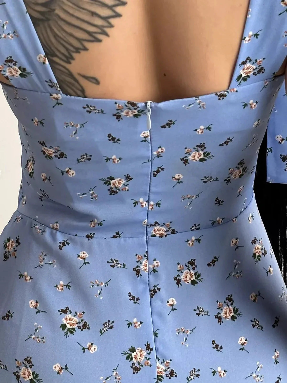 Close-up of the back of a Floral Charm Midi Dress with floral print and elegant shoulder ties.