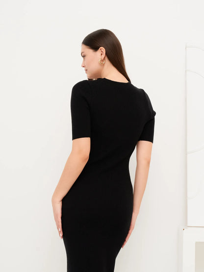 Back view of the black Sculpted Grace Midi Dress showcasing its fitted rib knit design and modern elegance.