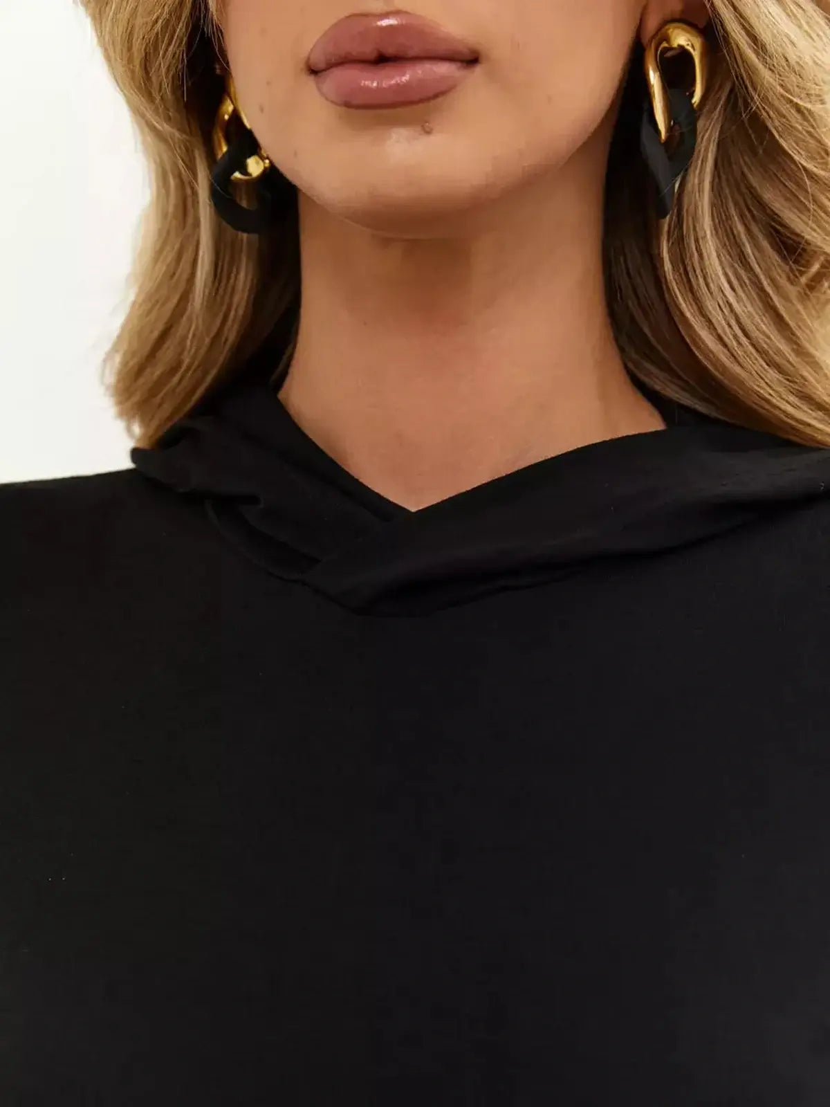 Close-up of a woman wearing a black hoodie from the Noir Maxi Dress, showcasing elegance and minimalist design.