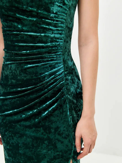 Close-up of the Velvet Aura Maxi Dress showcasing luxurious green velvet and elegant ruching details.
