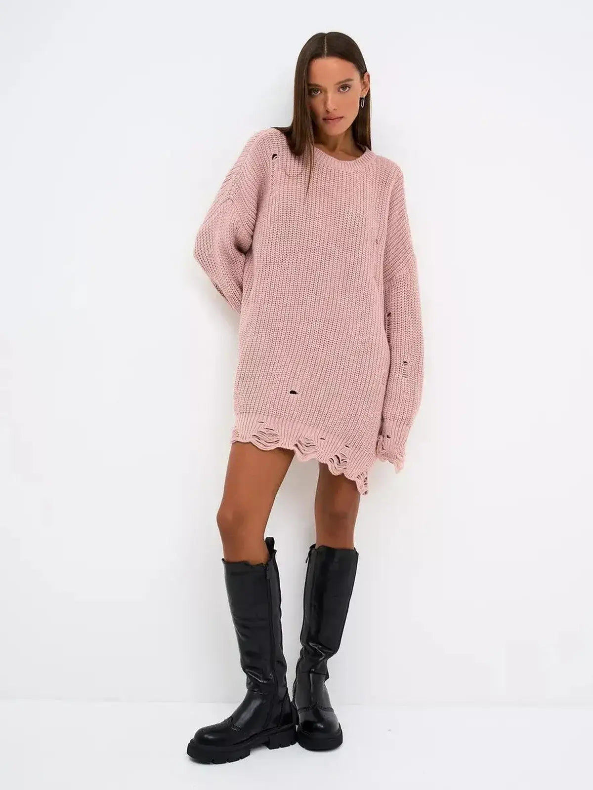 Model wearing the Blush Edge Mini, a dusty pink oversized sweater dress with distressed design and long sleeves.