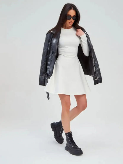 Model wearing the Ivory Sculpt Dress with a black leather jacket and chunky boots, showcasing a stylish summer dress.