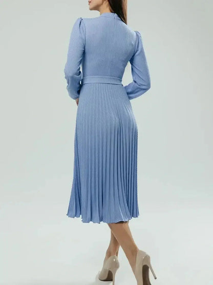 Back view of an Elegance Midi Dress in powder blue, featuring pleats and long sleeves, ideal for weddings or formal events.