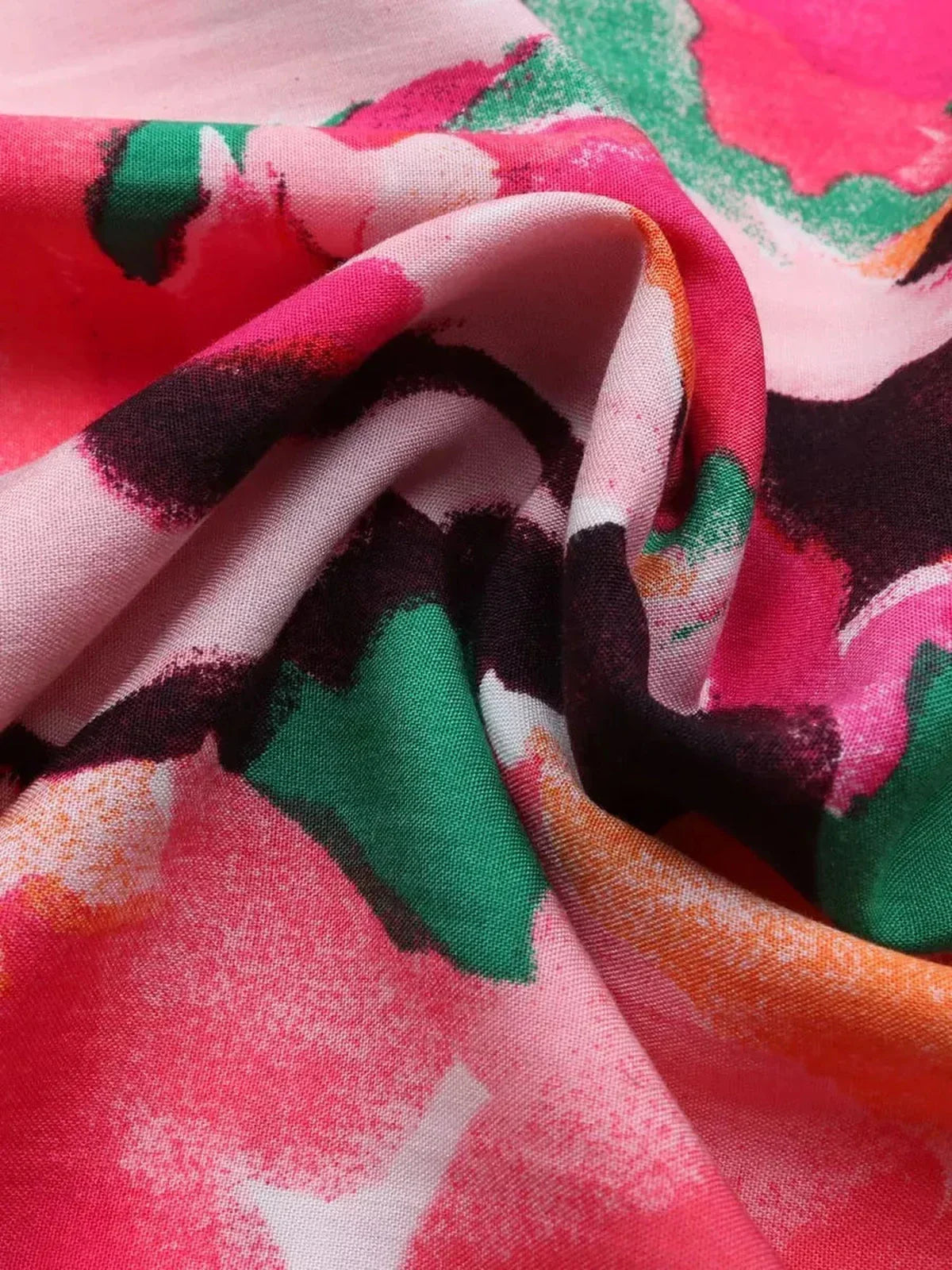 Close-up of vibrant, floral-patterned fabric showcasing colors perfect for summer dresses and midi dress designs.