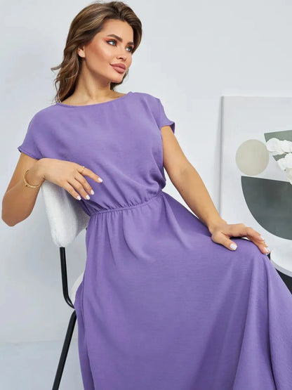 Woman modeling a lightweight lavender maxi dress with gathered waist for summer elegance and comfort.