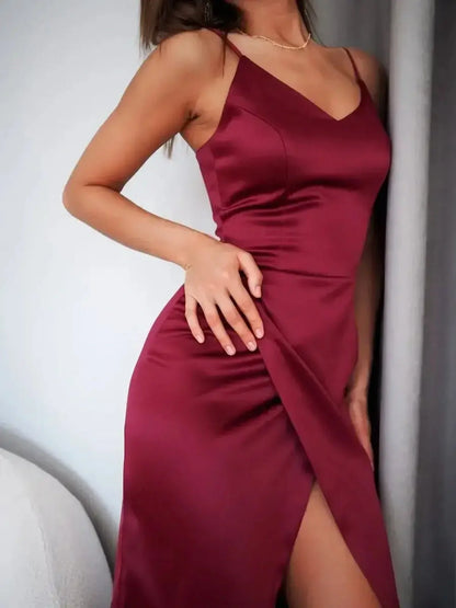 Crimson Luxe Midi Dress in glossy burgundy satin with a sultry side slit and adjustable straps, ideal for formal events.