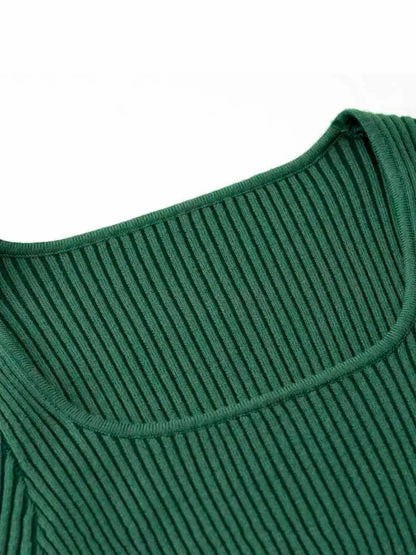 Close-up of the ribbed neckline of the Sculpted Knit Midi Dress in rich forest green.