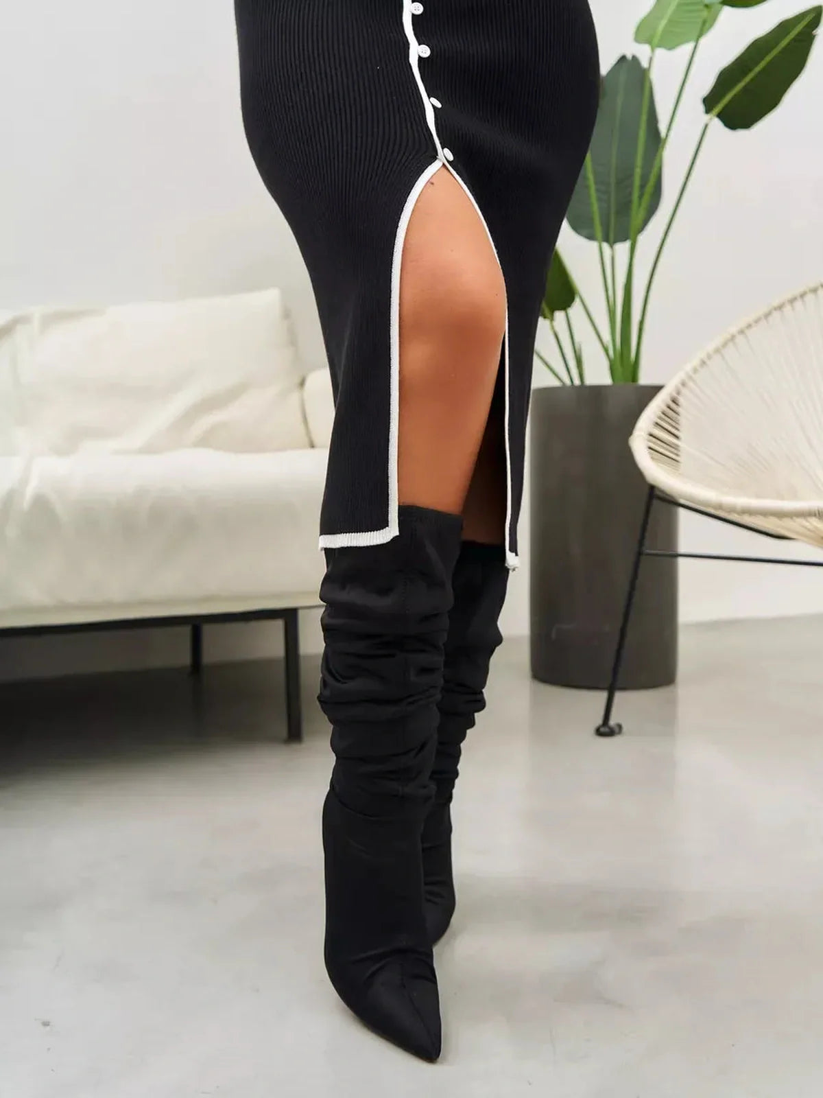 Detail of the Contrast Button Midi Dress featuring a side slit and stylish knee-high boots.