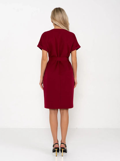 Back view of a woman in a crimson mini dress with a structured silhouette and detachable belt, ideal for summer or formal occasions.