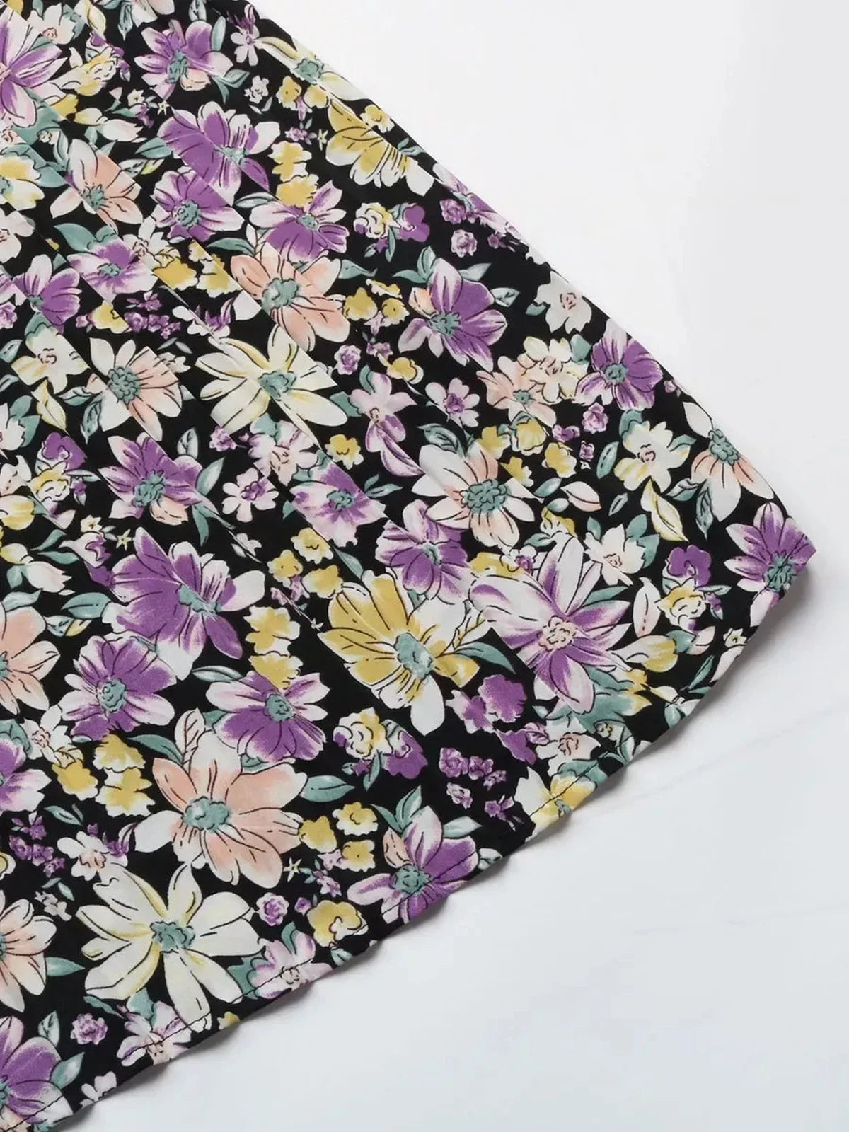 Floral pattern of the Botanic Bloom Midi Dress featuring colorful blooms on a black background, perfect summer attire.