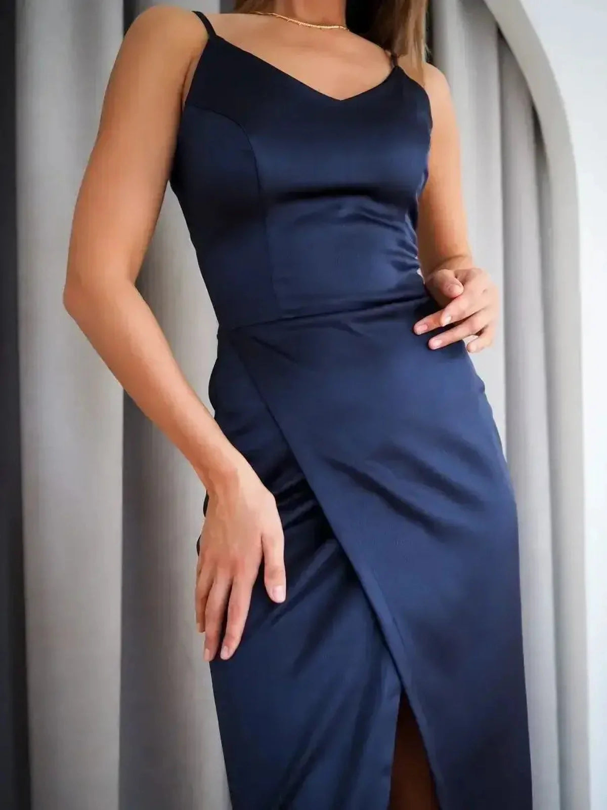 Midnight Charm Midi Dress in deep navy satin showcasing a sleek silhouette and V-neckline, ideal for formal and wedding occasions.