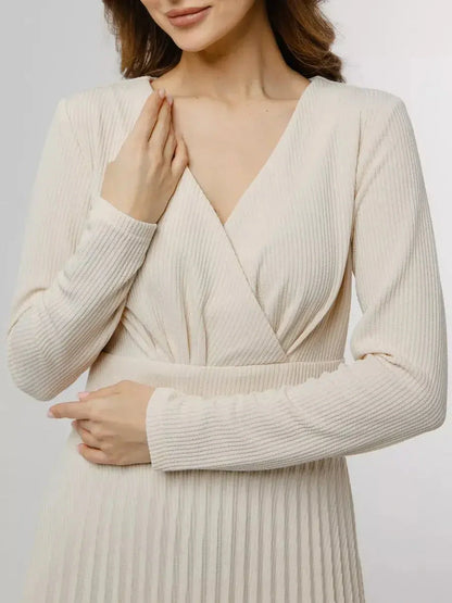 Model showcasing the Ivory Grace Midi Dress, featuring a V-neckline and pleated design for elegance.