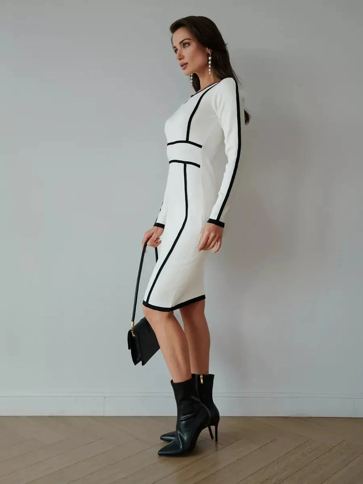 Elegant white midi dress with black piping, perfect for formal events and stylish everyday wear.
