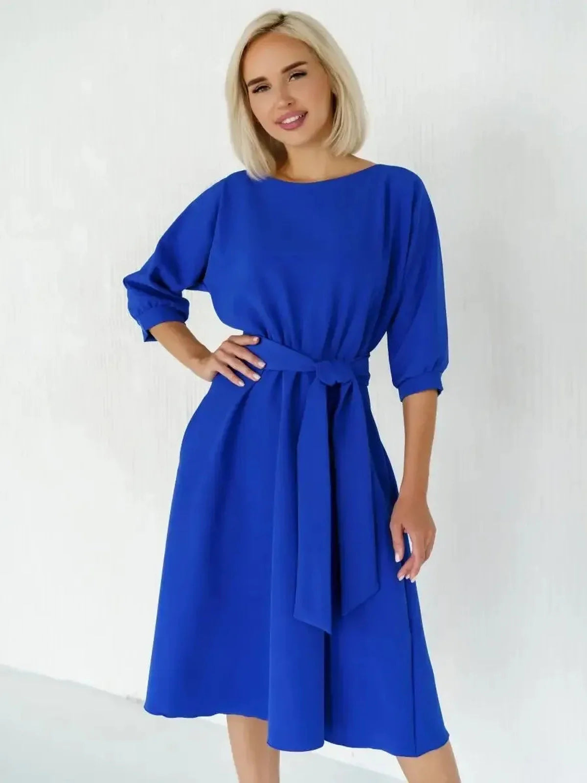 Sapphire belted midi dress featuring a structured boat neckline and fluid A-line silhouette in electric blue.