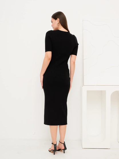 Back view of the Sculpted Grace Midi Dress, a fitted black rib knit dress with modern silhouette.