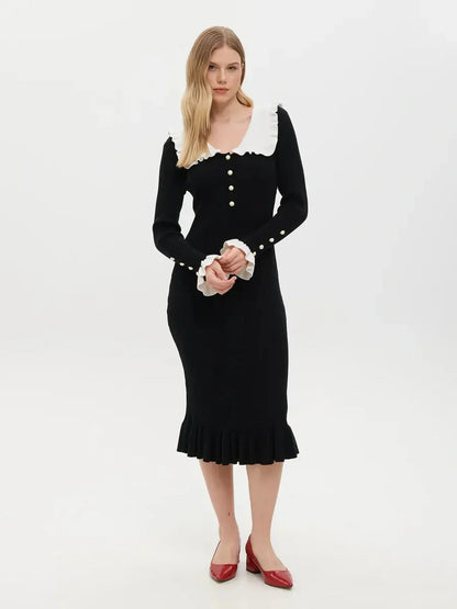 Elegant black midi dress with ruffle collar and pearl button details, perfect for weddings and formal occasions.