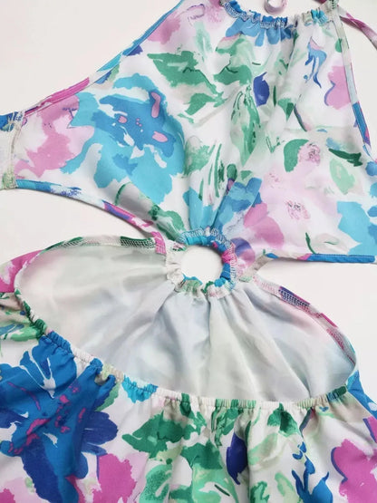 Halter-neck design of the Petal Bloom Midi Dress featuring a vibrant watercolor floral print in pink, teal, and green.