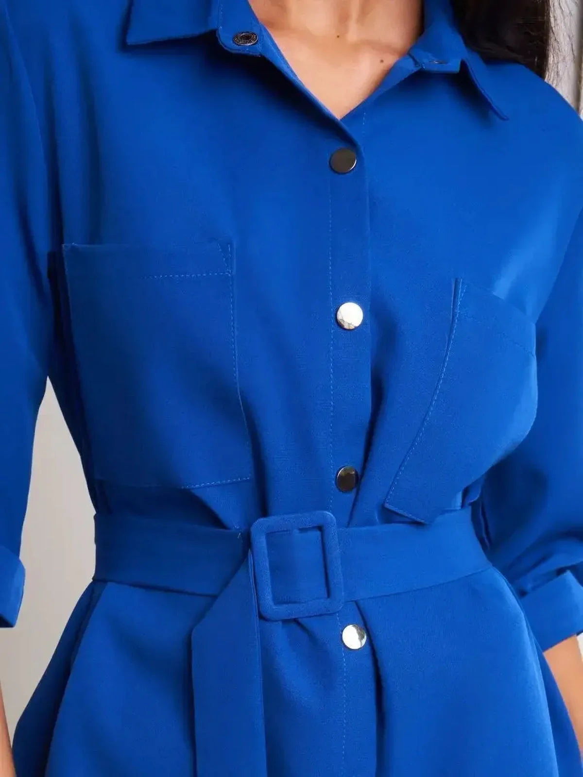 Close-up of Cobalt Charm Mini Dress featuring a belted waist and structured design, perfect for weddings and special events.