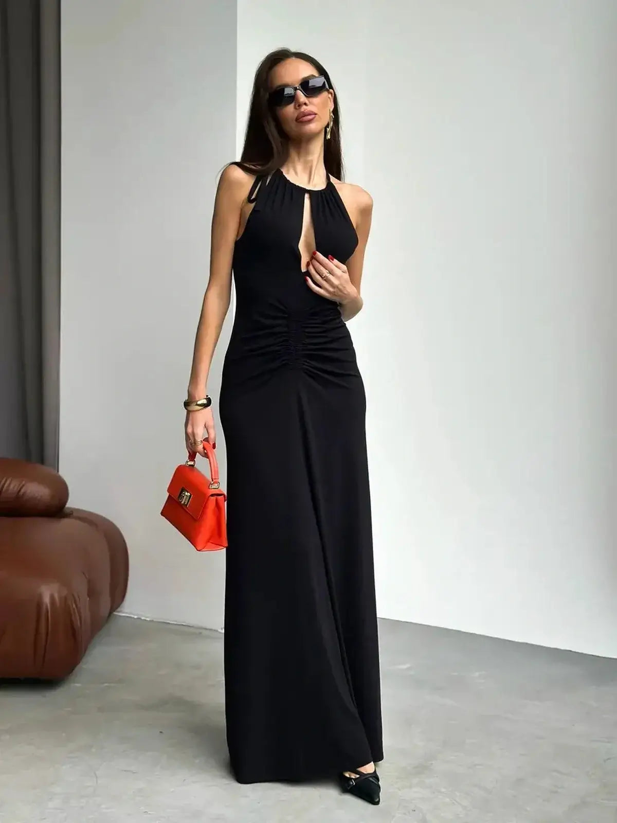 Elegant black maxi dress with halter neckline and front keyhole, perfect for evening events and summer gatherings.