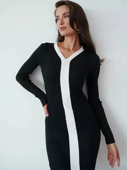 Elegant black midi dress with contrast white piping and V-neckline, perfect for formal events or as a wedding guest dress.