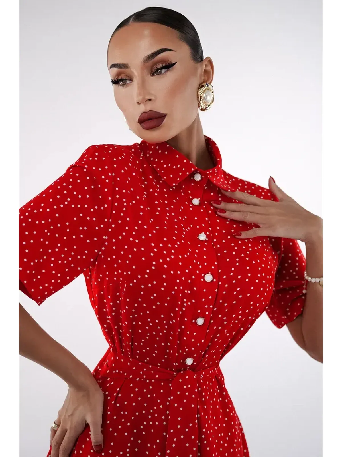 Model showcasing the vibrant red Scarlet Dot Midi Dress with polka dots and a flattering collar.