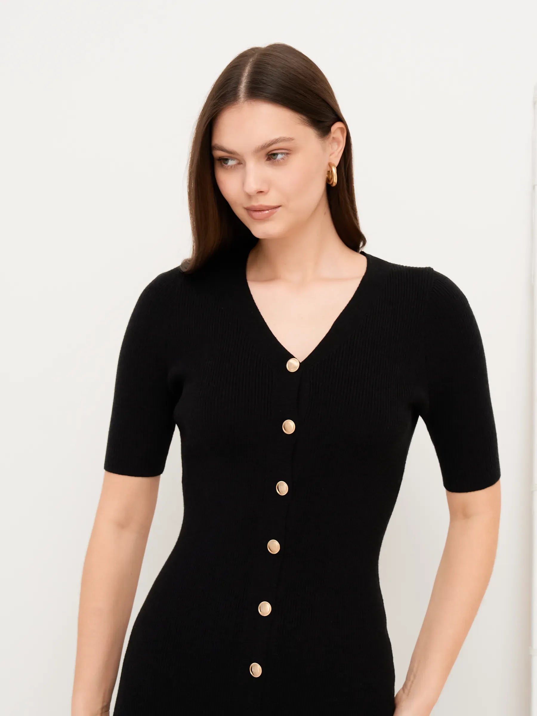 Sculpted Grace Midi Dress in black with gold button detail, perfect for weddings, cocktail events, and formal occasions.