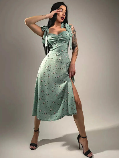 Flora Grace Midi Dress featuring romantic florals, statement bows, and a thigh-high slit for elegant spring events.