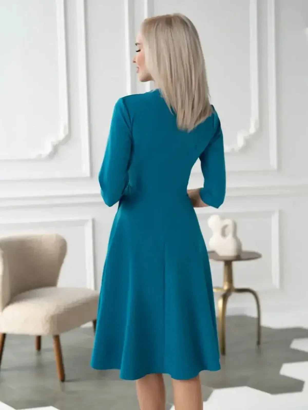 Back view of the Sea Grace Midi Dress in sea wave teal, showcasing its elegant wrap style and A-line silhouette.