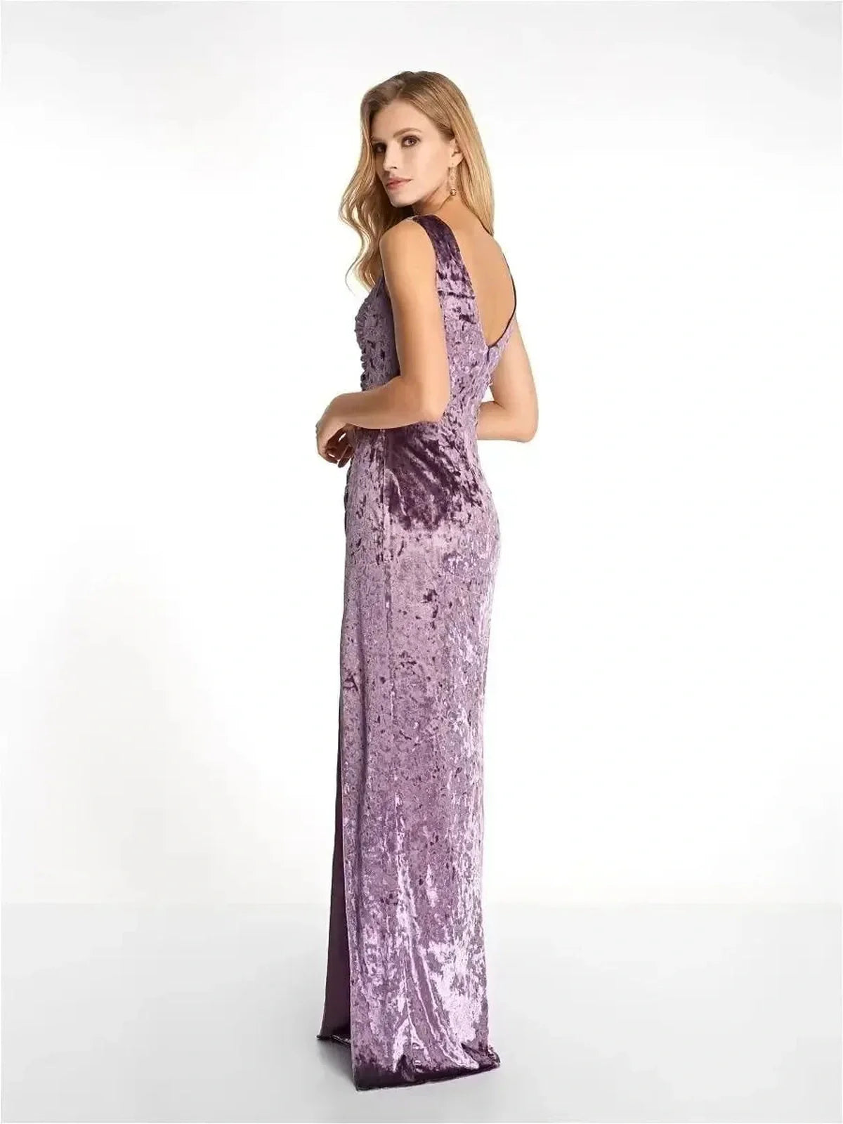 Elegant purple velvet maxi dress with a sculpted fit and deep V-back, perfect for formal events and wedding guest outfits.