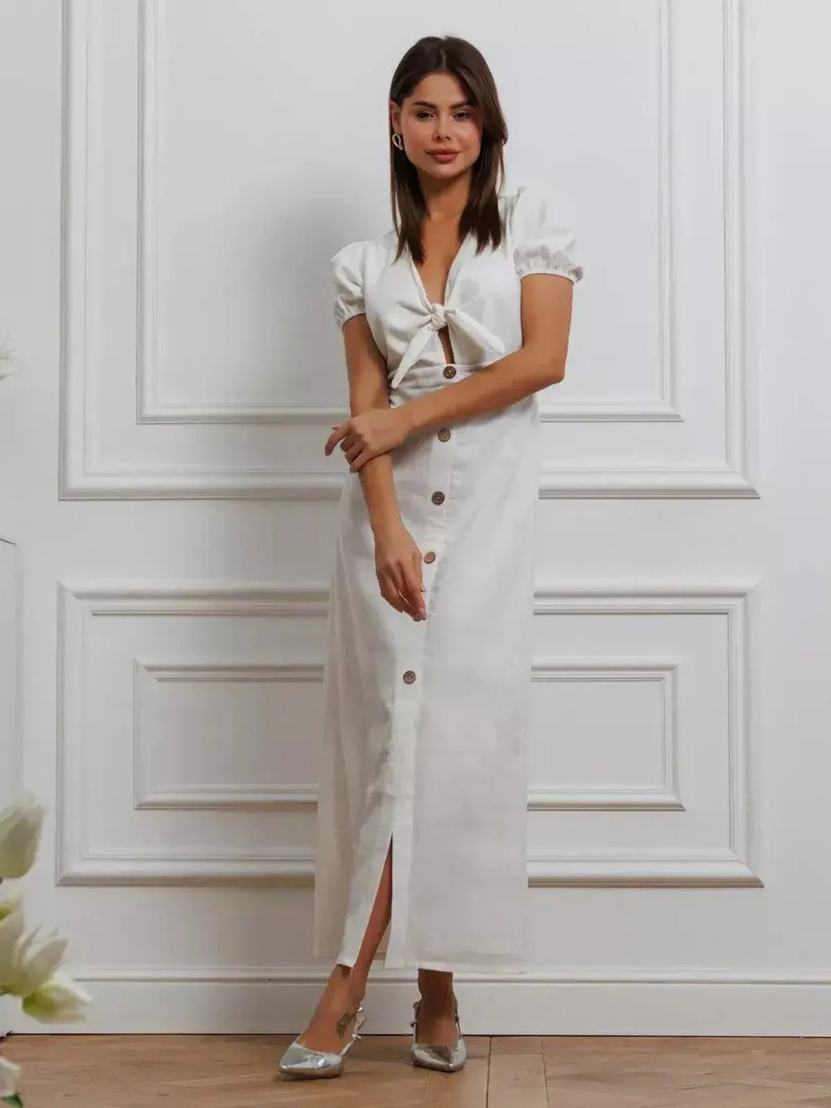 Elegant white maxi dress with tie-front and puff sleeves, perfect for weddings and summer events.