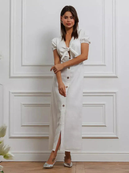 Elegant white maxi dress with tie-front and puff sleeves, perfect for weddings and summer events.
