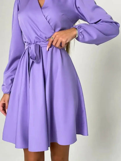 Elegant lilac mini dress with a V-neckline and cinched waist, perfect for weddings and formal events.