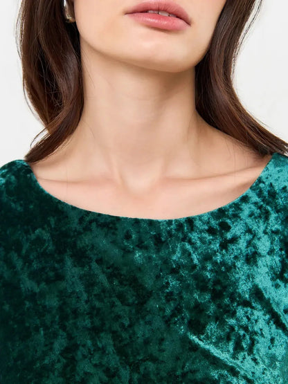 Close-up of the Velvet Aura Maxi Dress showcasing its lush green velvet fabric and elegant neckline design.