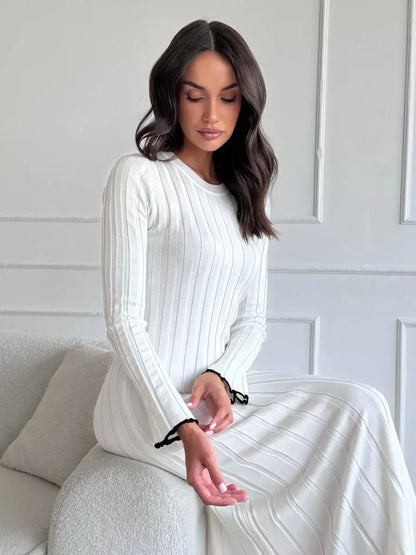 Ivory Grace Maxi Dress featuring ribbed texture and ruffle trim, perfect for weddings and elegant evening events.