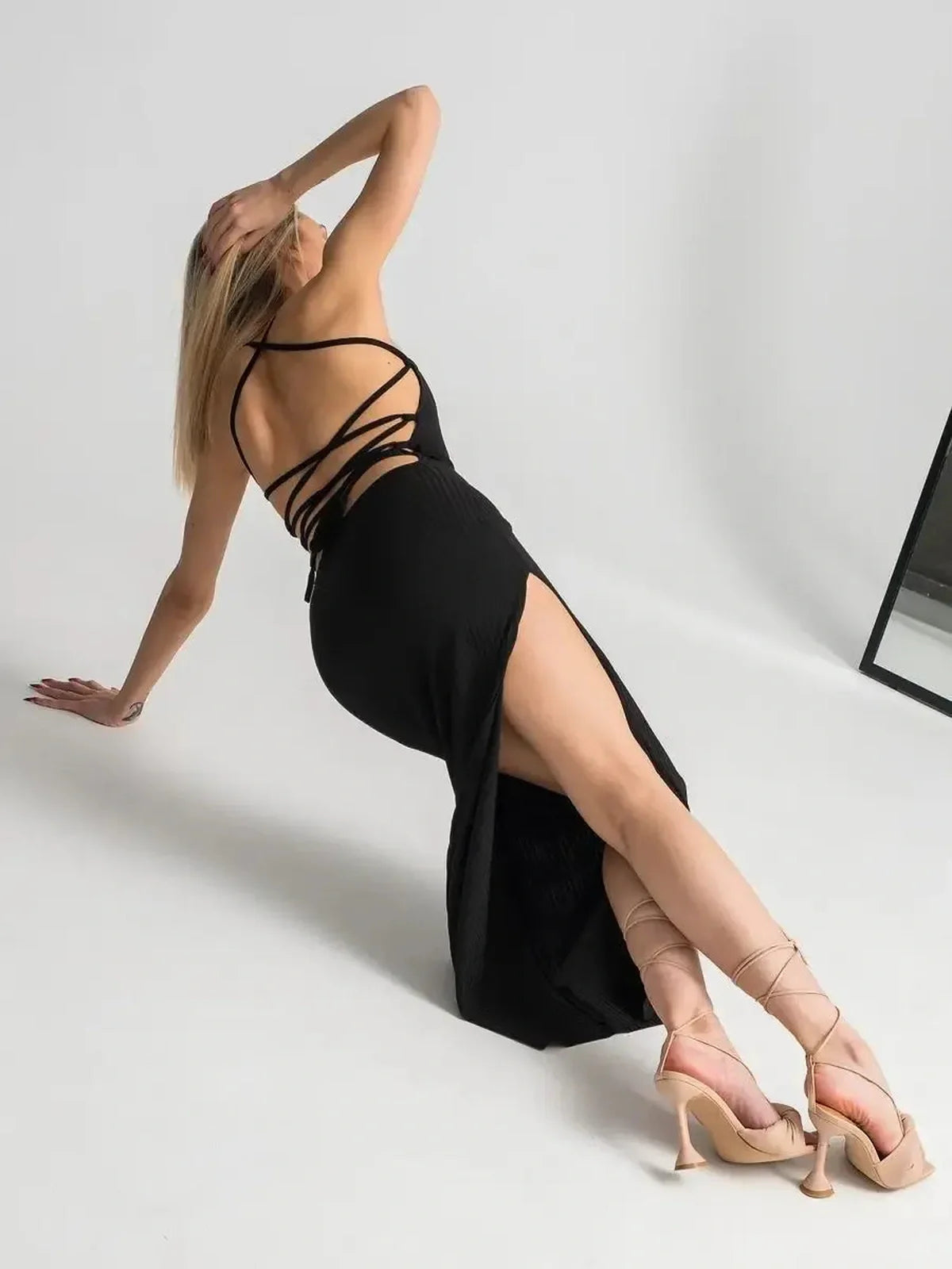 Women’s Noir Lace Midi Dress featuring an open lace-up back and thigh-high slit for an elegant, seductive look.