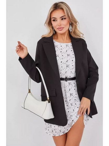 Stylish woman wearing Monochrome Muse Mini Dress with a black blazer, holding a white handbag for a chic look.